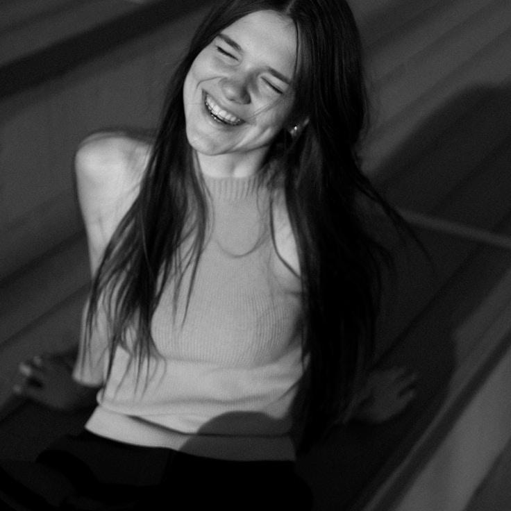 Kaveri Mehta, Lead Design Curator at Meadow Plume Bay, reviewing corporate floral arrangements